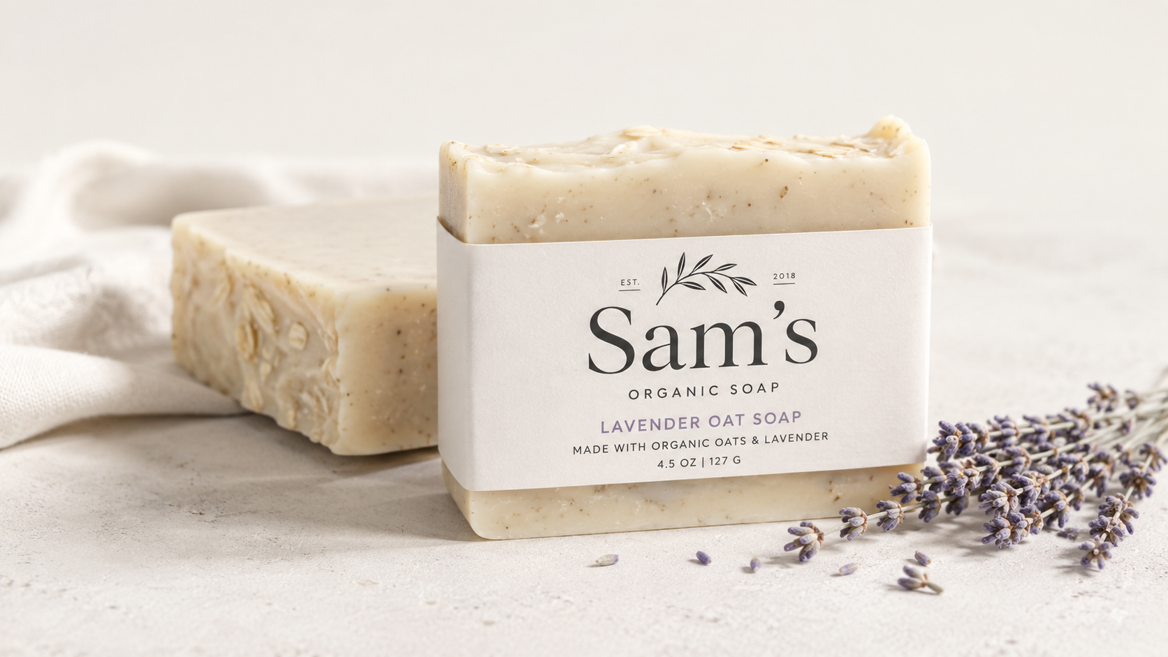 Lavender oat soap bar beside dried lavender